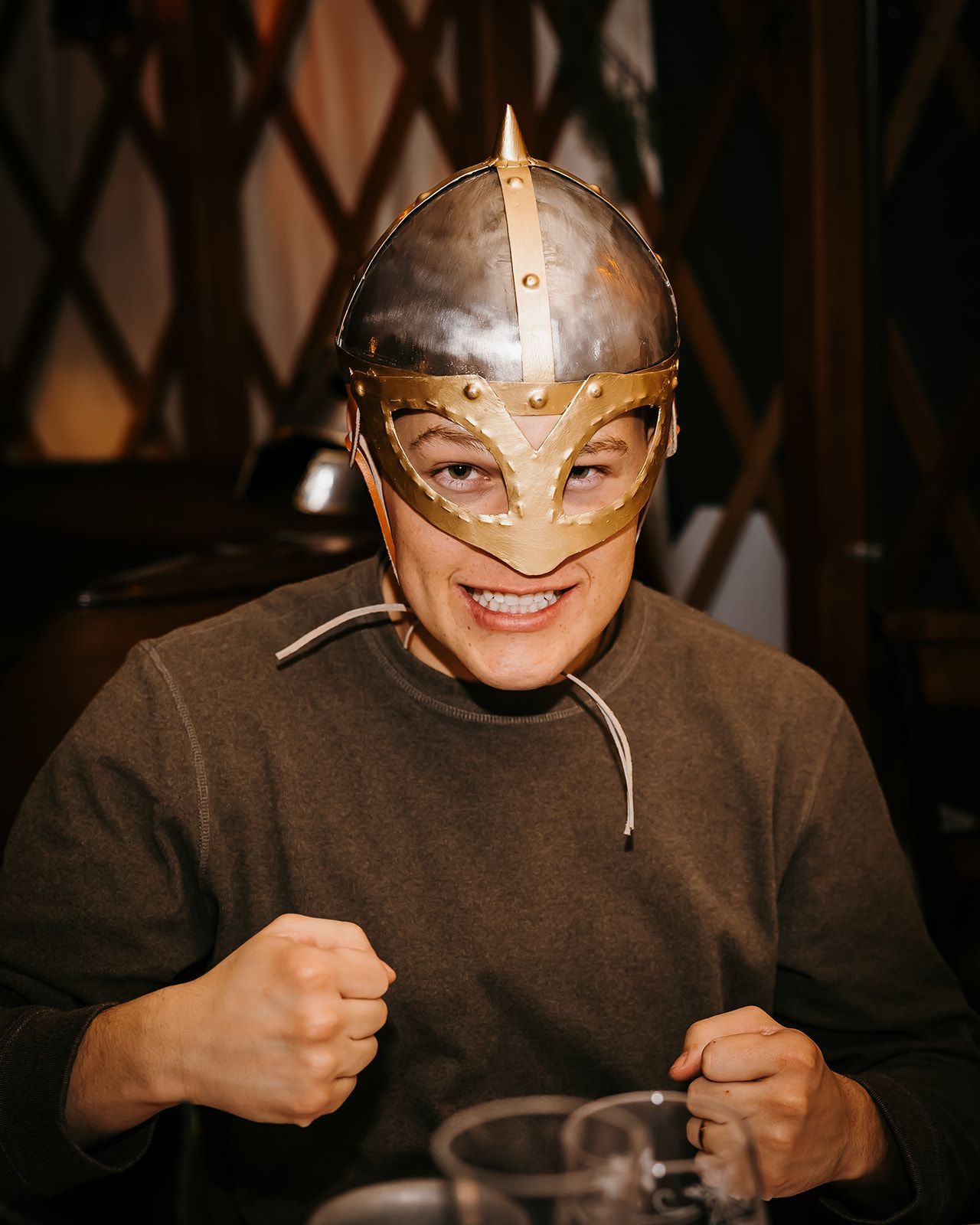 man grimmicing with viking helmet