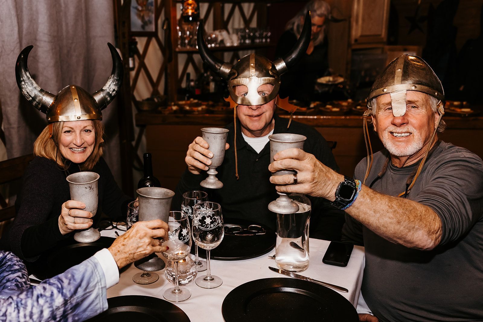 group holding drinks with viking helmets on