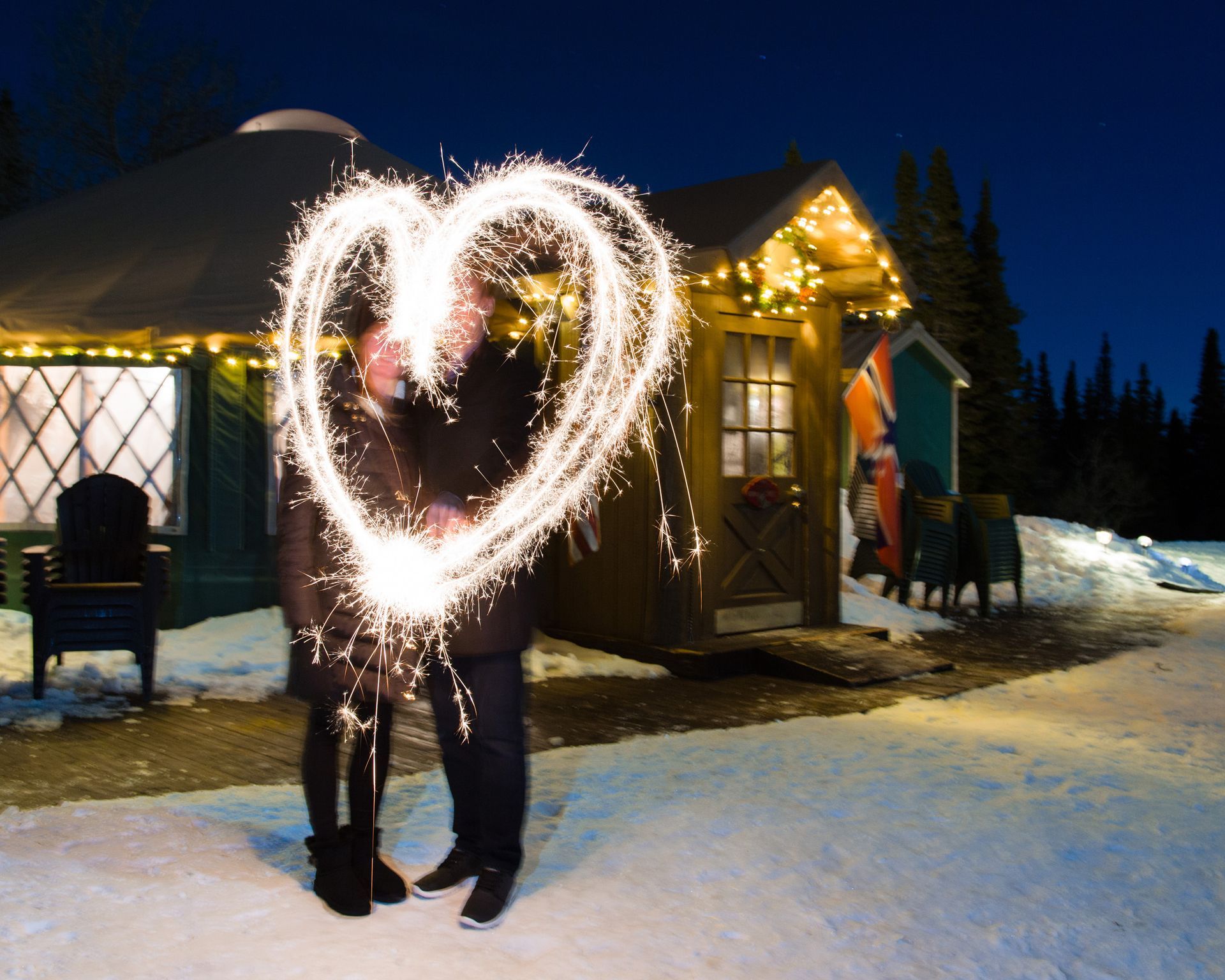 couple making a heart out of sparklers