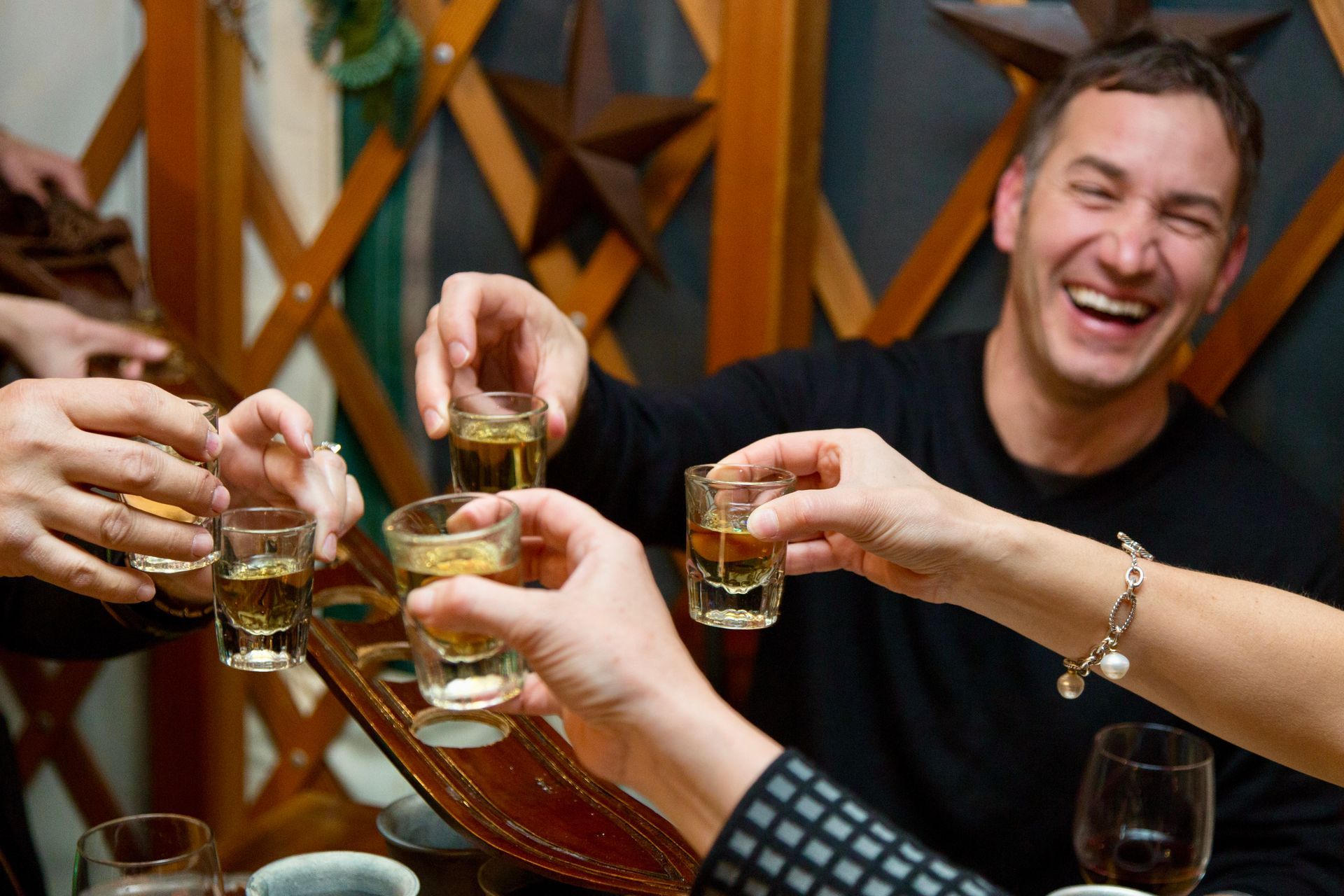 group doing cheers with shots