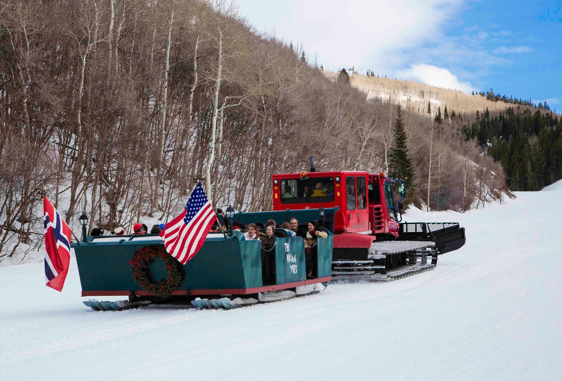 people enjoying the sleigh ride up the mountain