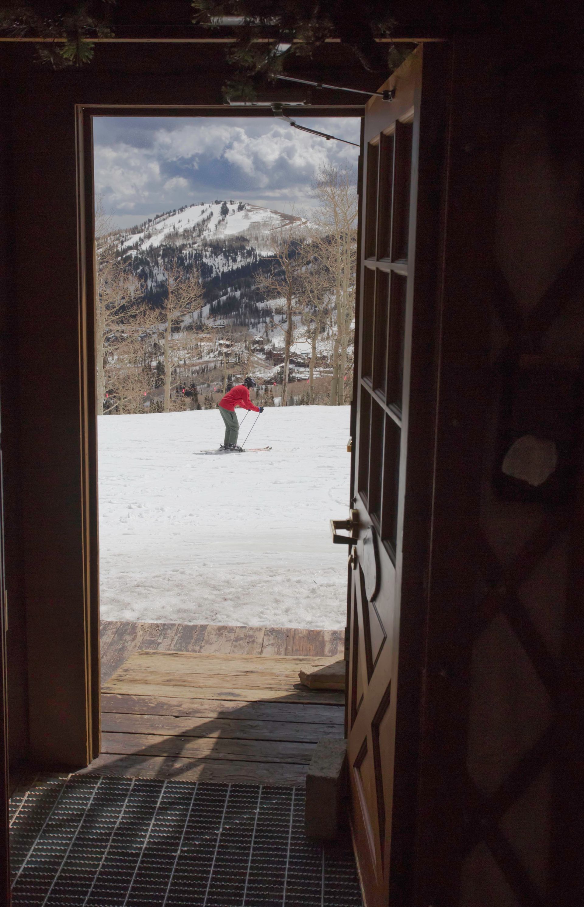 Person skiing past yurt