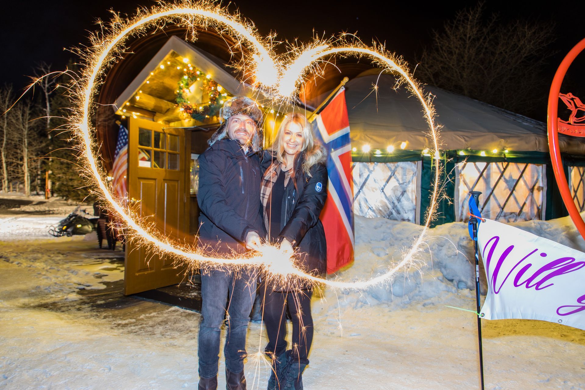 couple drawing a heart with a sparkler
