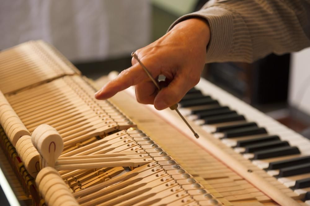 A Person Is Pointing at A Piano Keyboard with Their Finger — David Simpson Pty Ltd in Innisfail, QLD