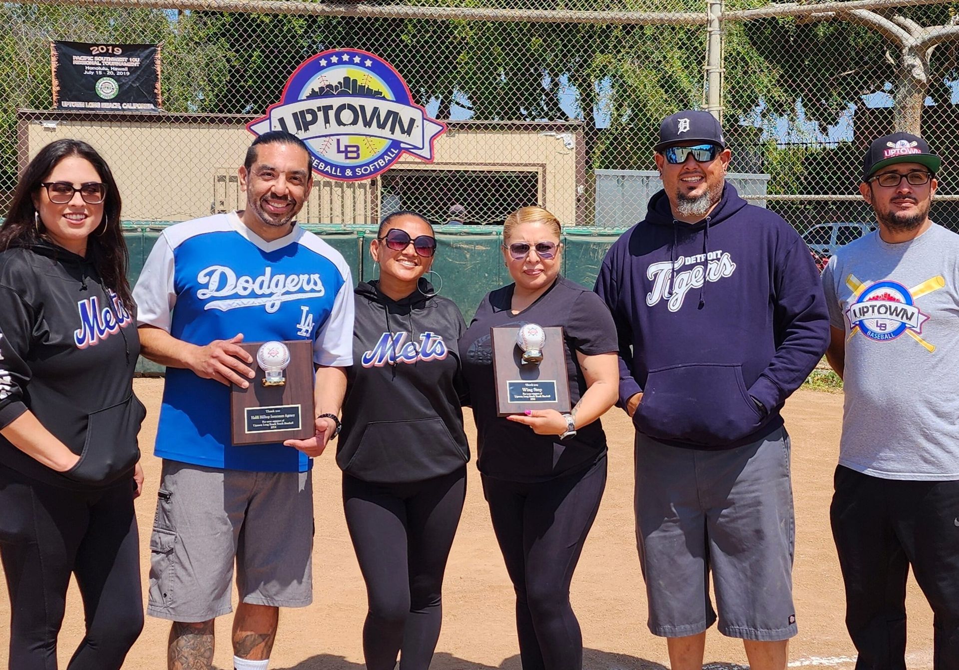 People holding awards in front of an 