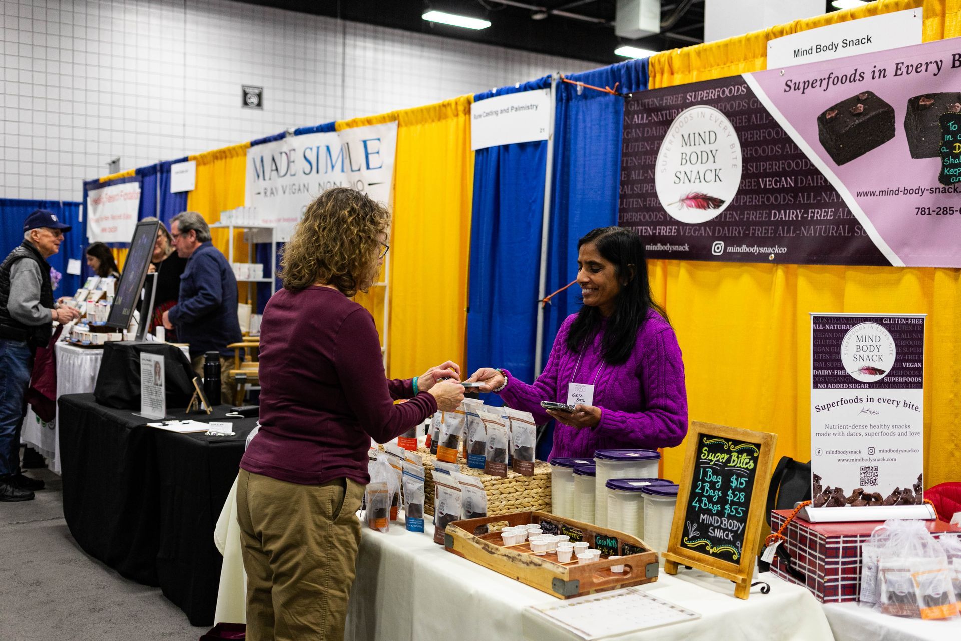 A large group of people are walking through a convention hall