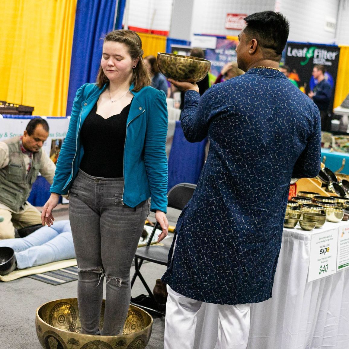 A man is holding a bowl in front of a sign that says healthy foot