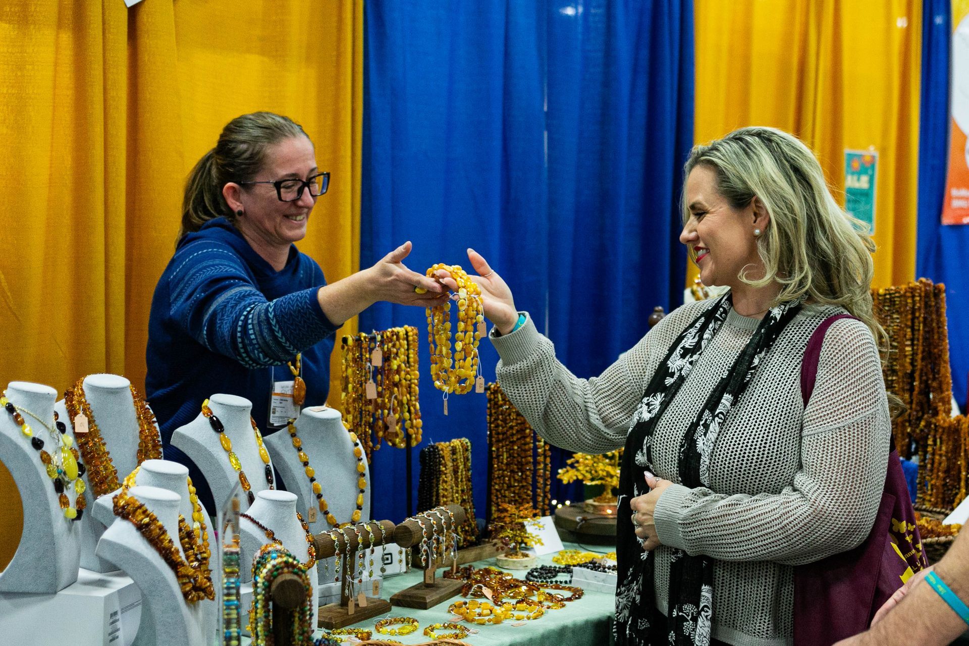 A group of people are standing around a table at a convention