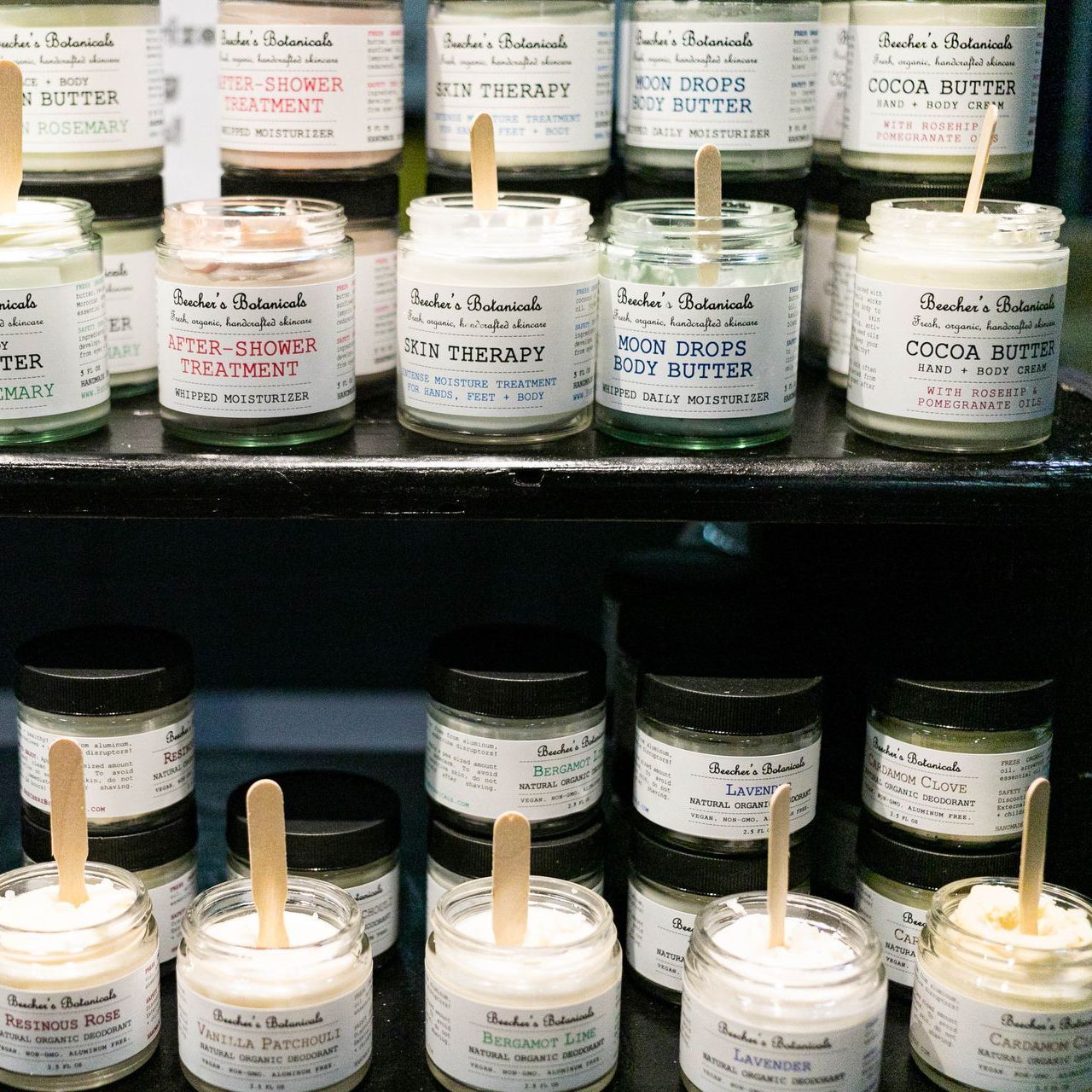 A man stands in front of a sign that says sam 's soulutions