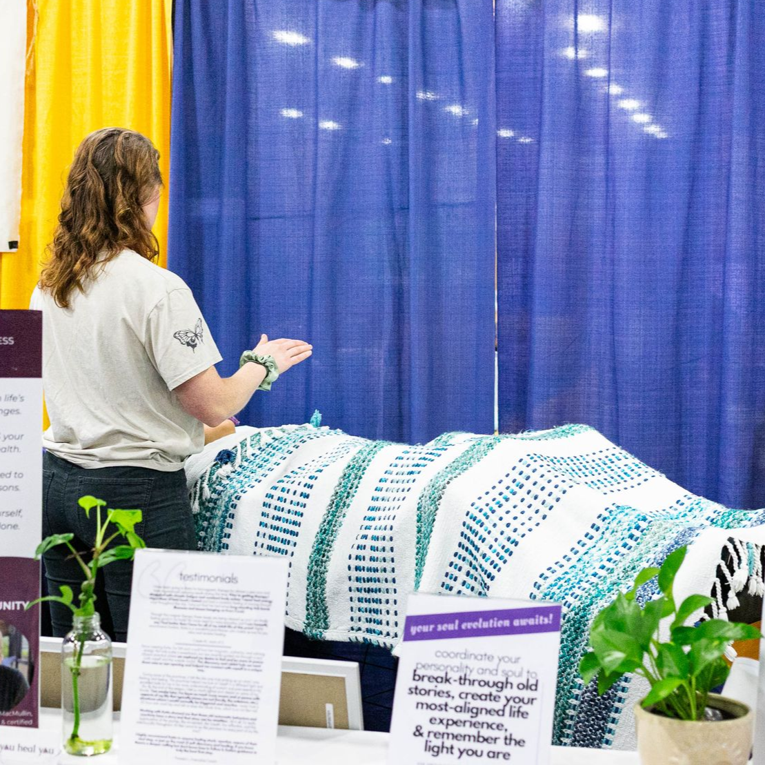 A woman laying on the floor with a bag that says oxa on it