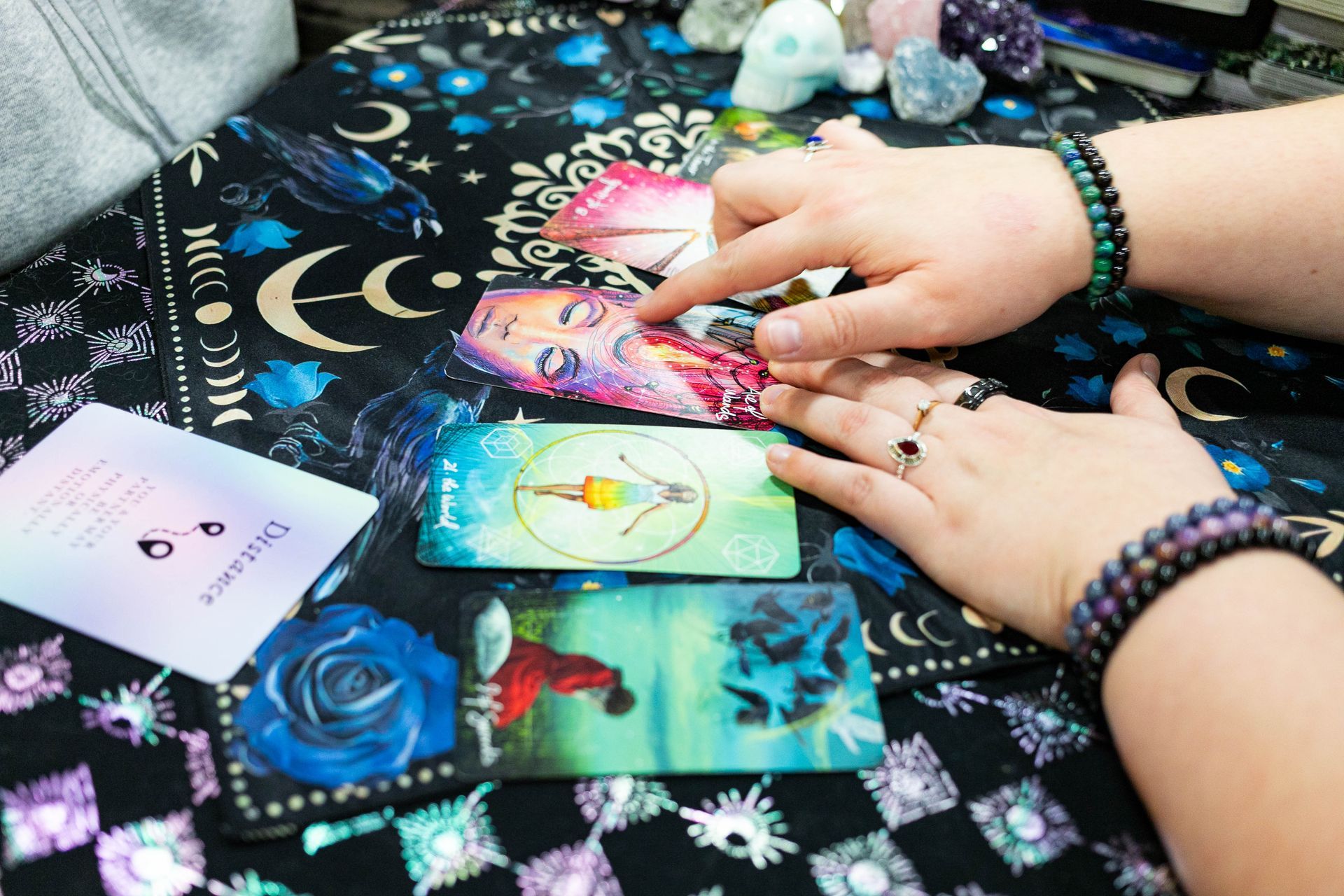 A woman is sitting at a table talking to another woman