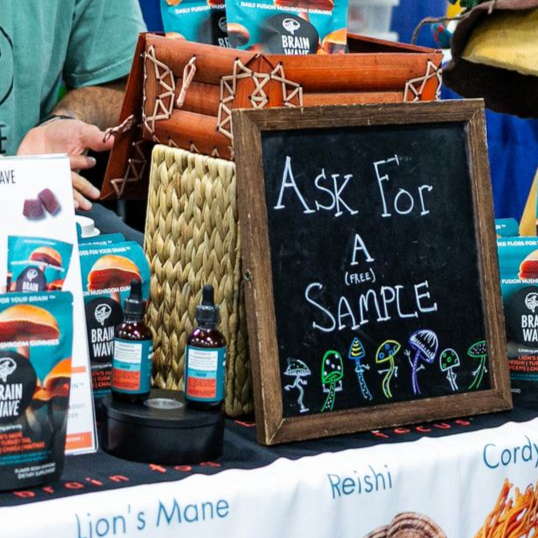 Two people standing in front of a table that says healing