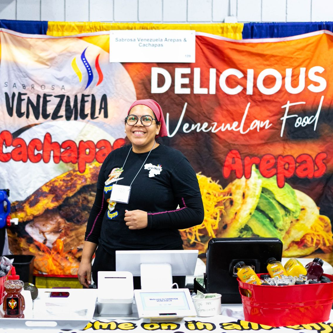 A woman standing in front of a sign that says 