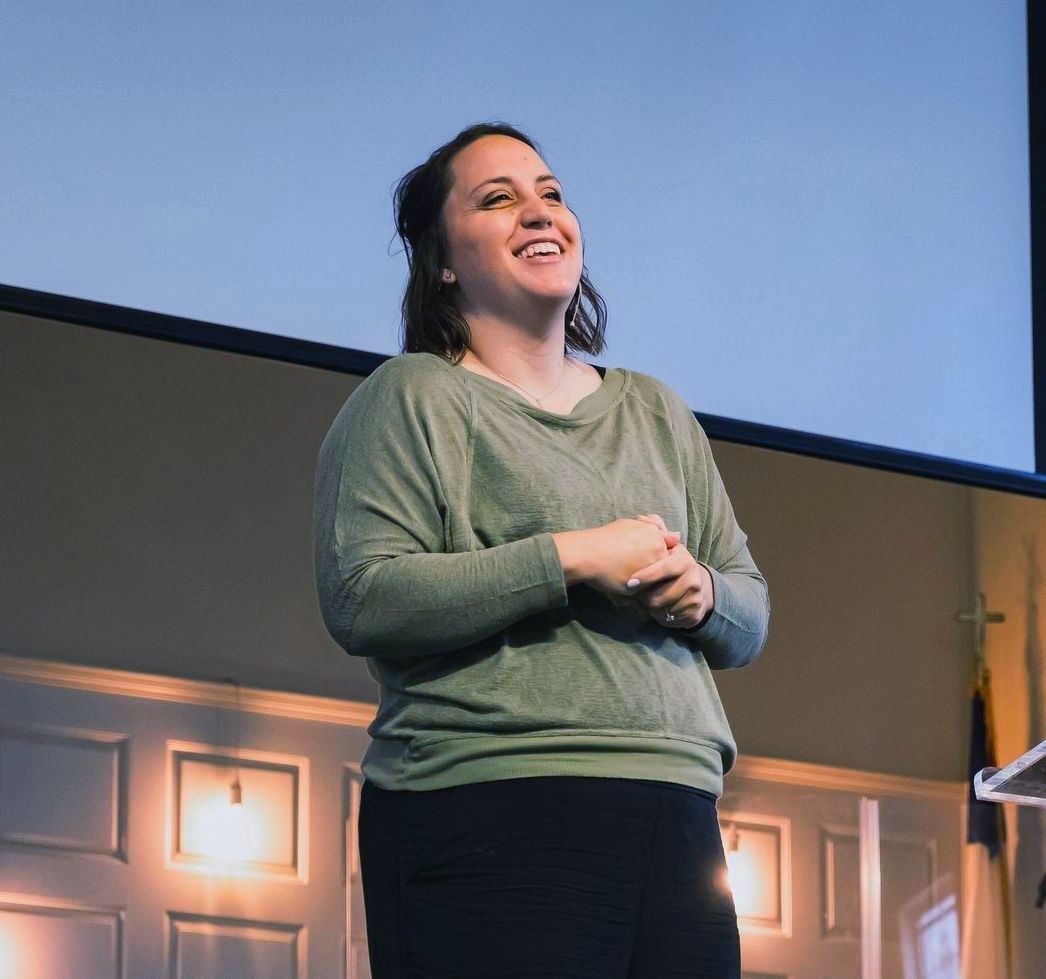 Gloria Givens in a green shirt is smiling 