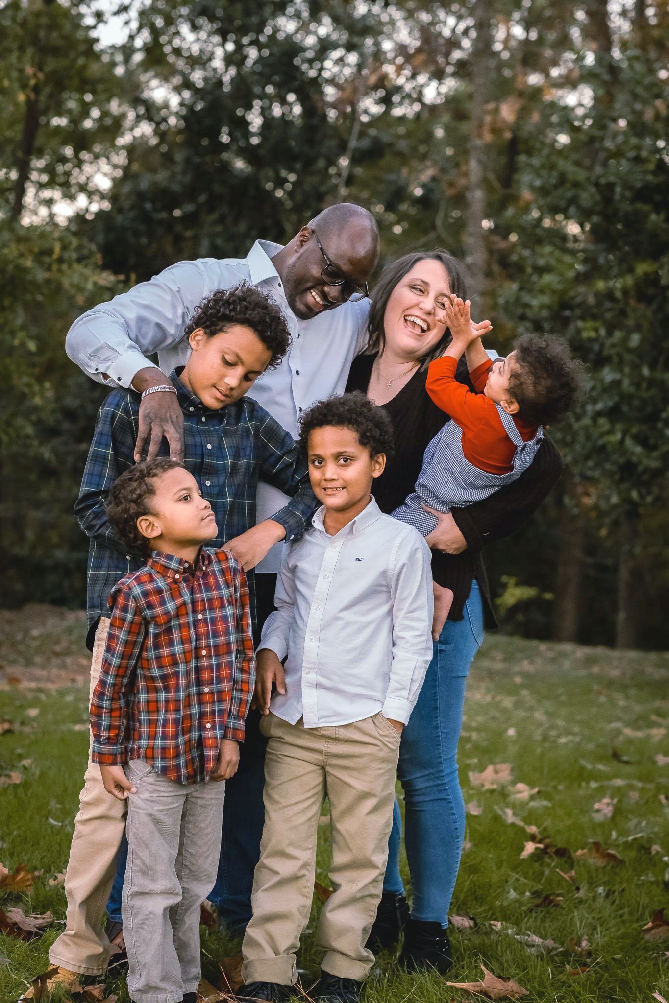Givens family is posing for a picture in a park.
