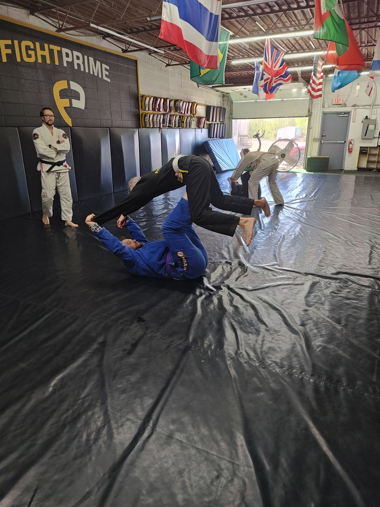 A group of people are practicing martial arts in a gym.