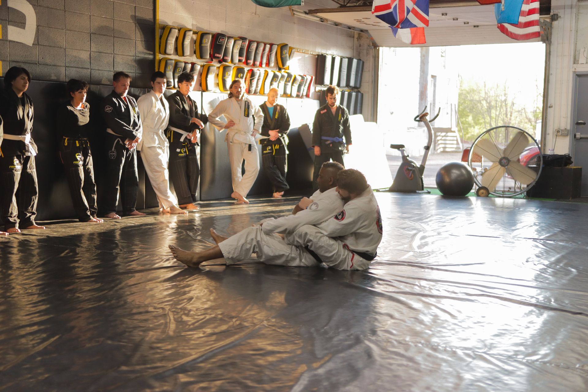 A group of people are practicing martial arts in a gym