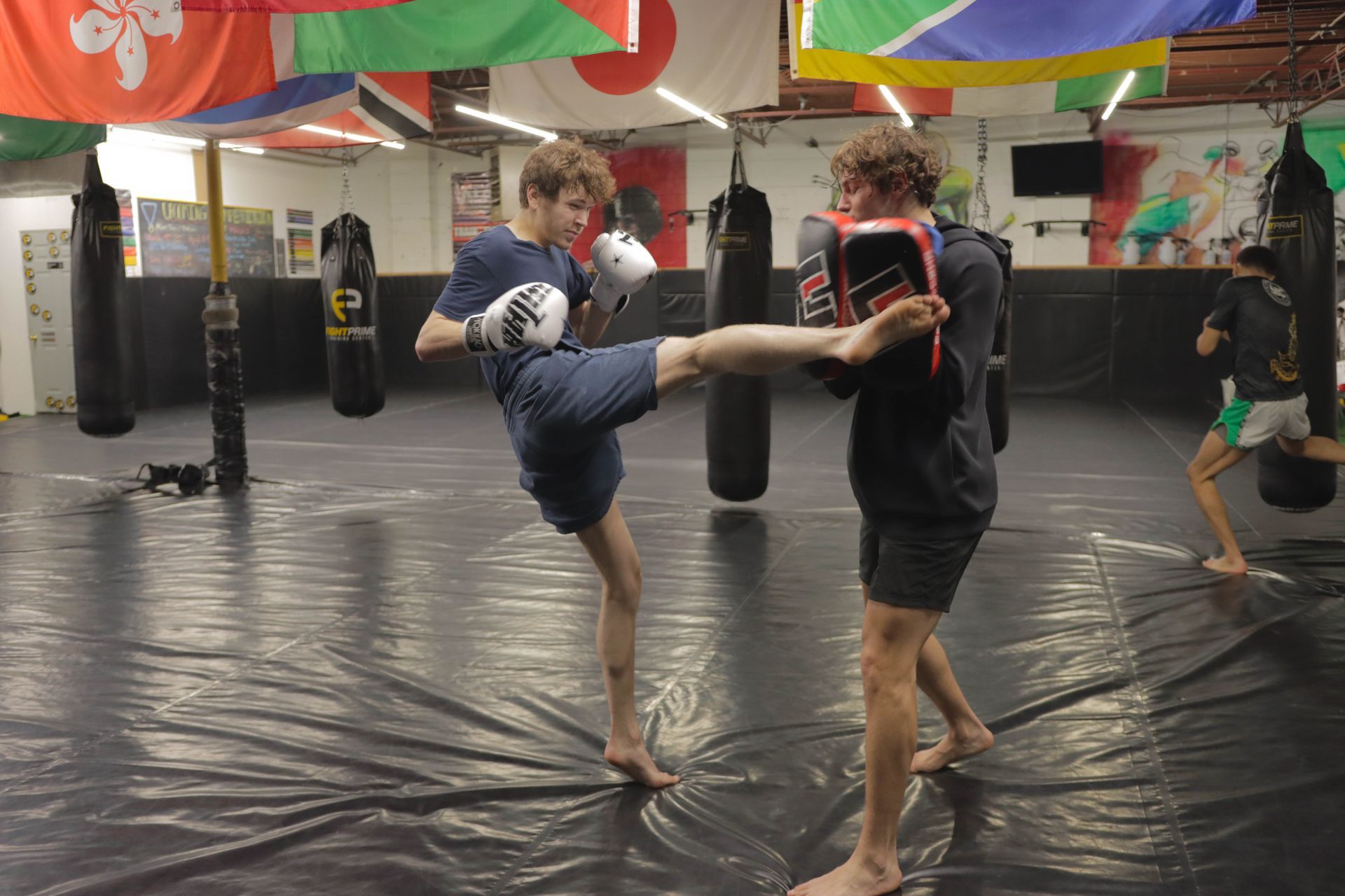 Two men are doing Muay Thai Kickboxing