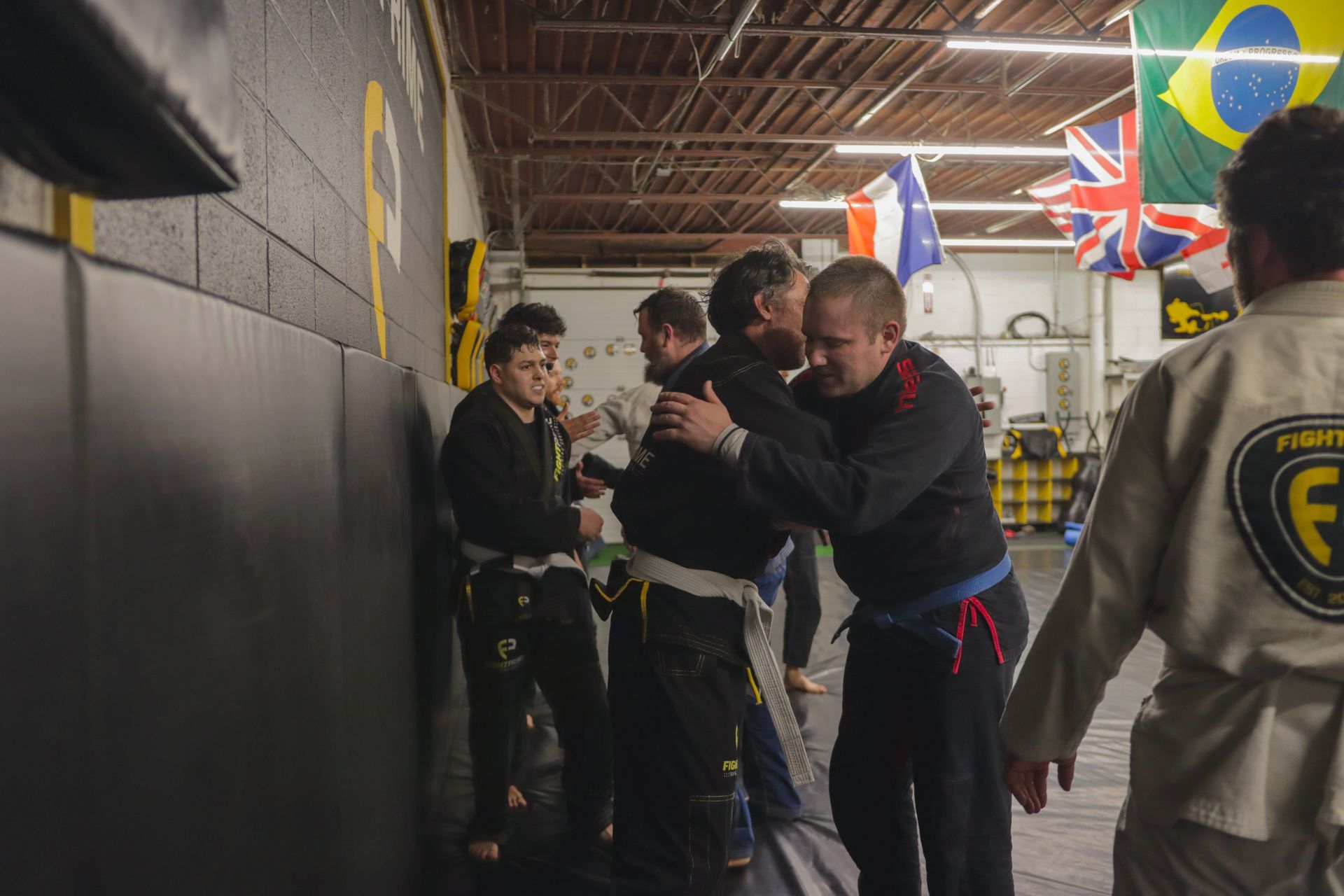 A group of people are practicing martial arts in a gym.