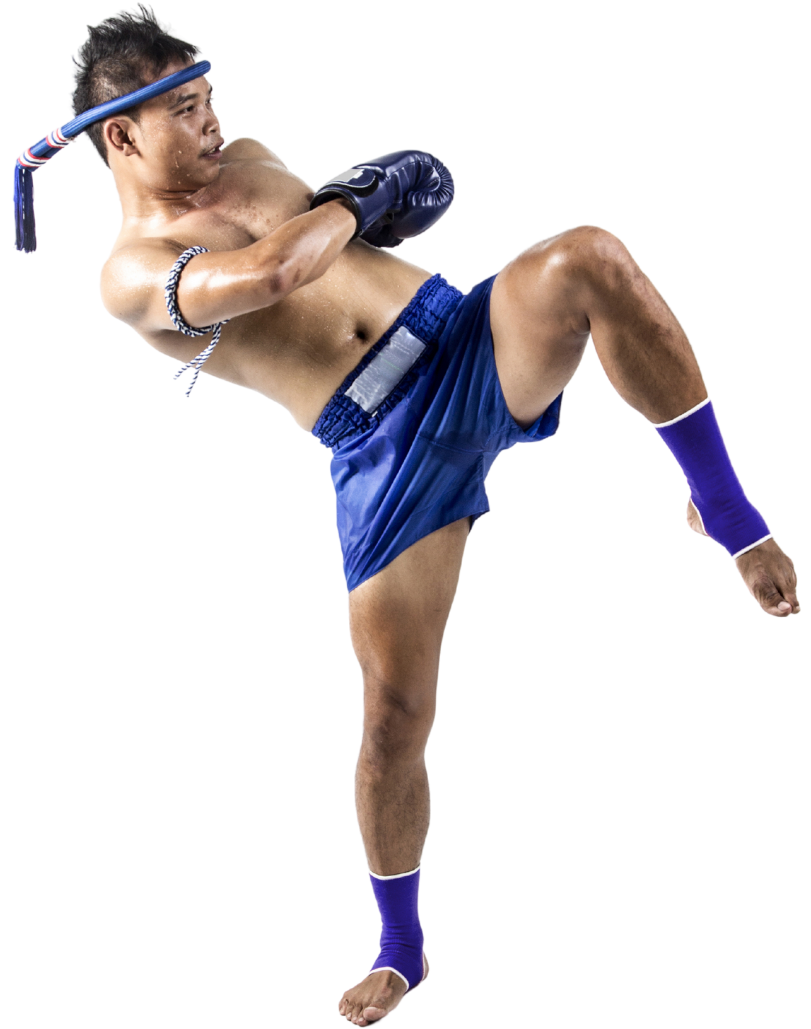 A man in blue shorts and boxing gloves is kicking in the air.