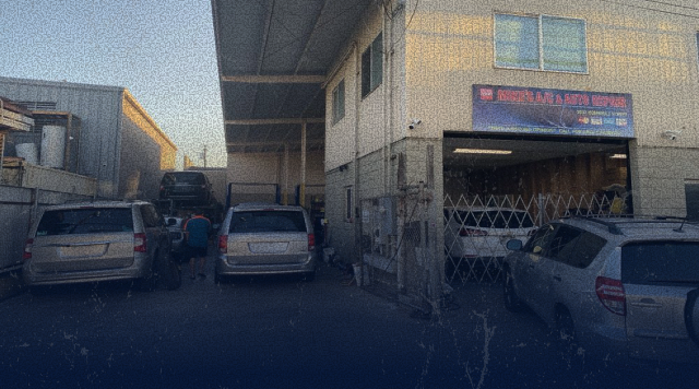 Cars parked at a repair shop with a sign; exterior view | Mike's Automotive AC