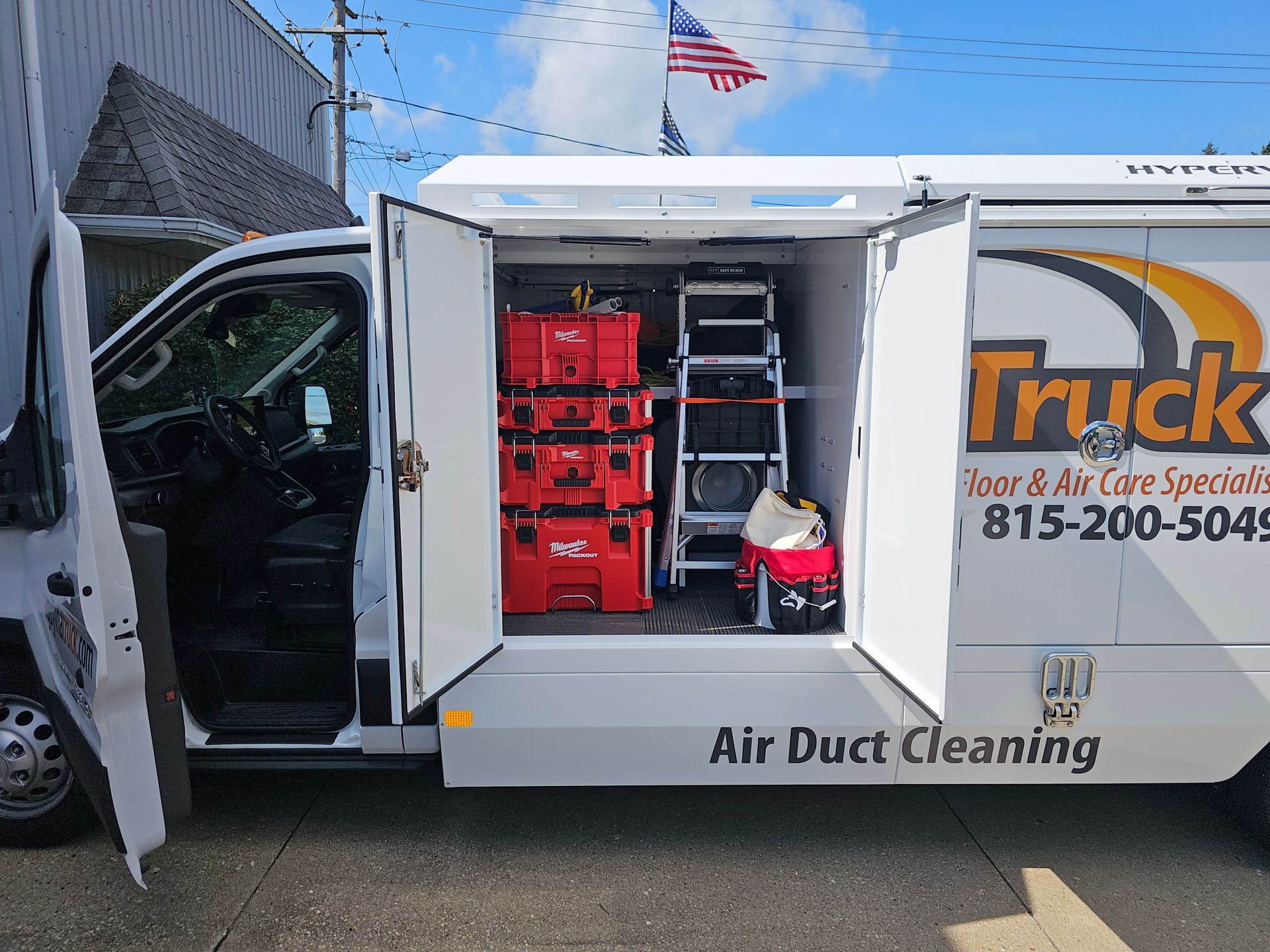 Side view of A Guy in a Truck air duct cleaning vehicle with organized tools and equipment inside.