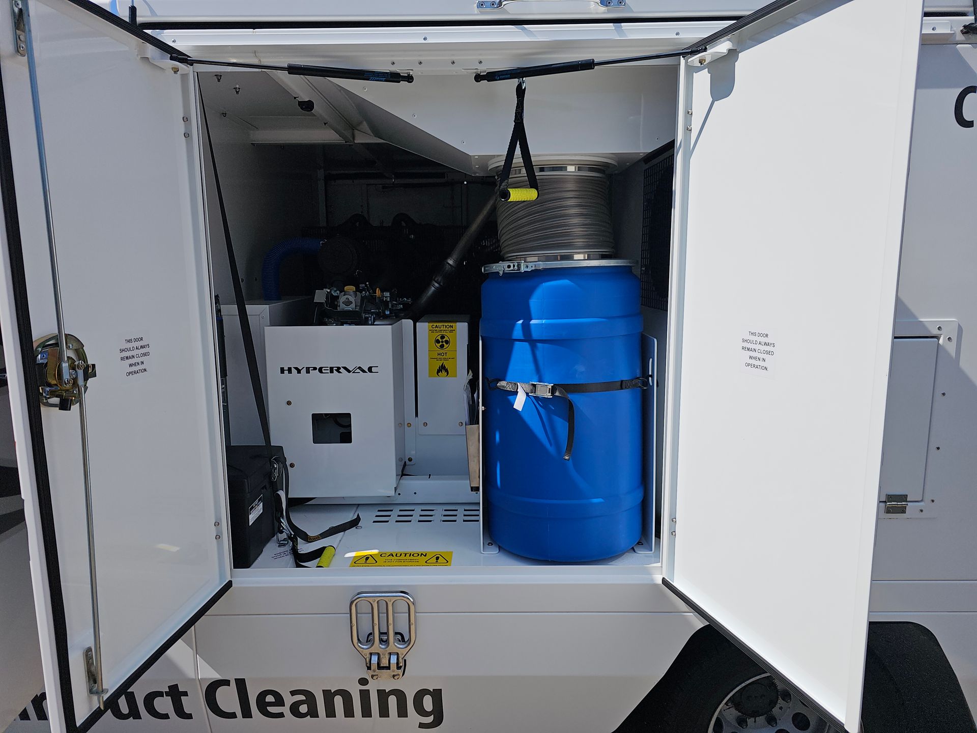 Open compartment of A Guy in a Truck air duct cleaning vehicle showing HyperVac equipment.
