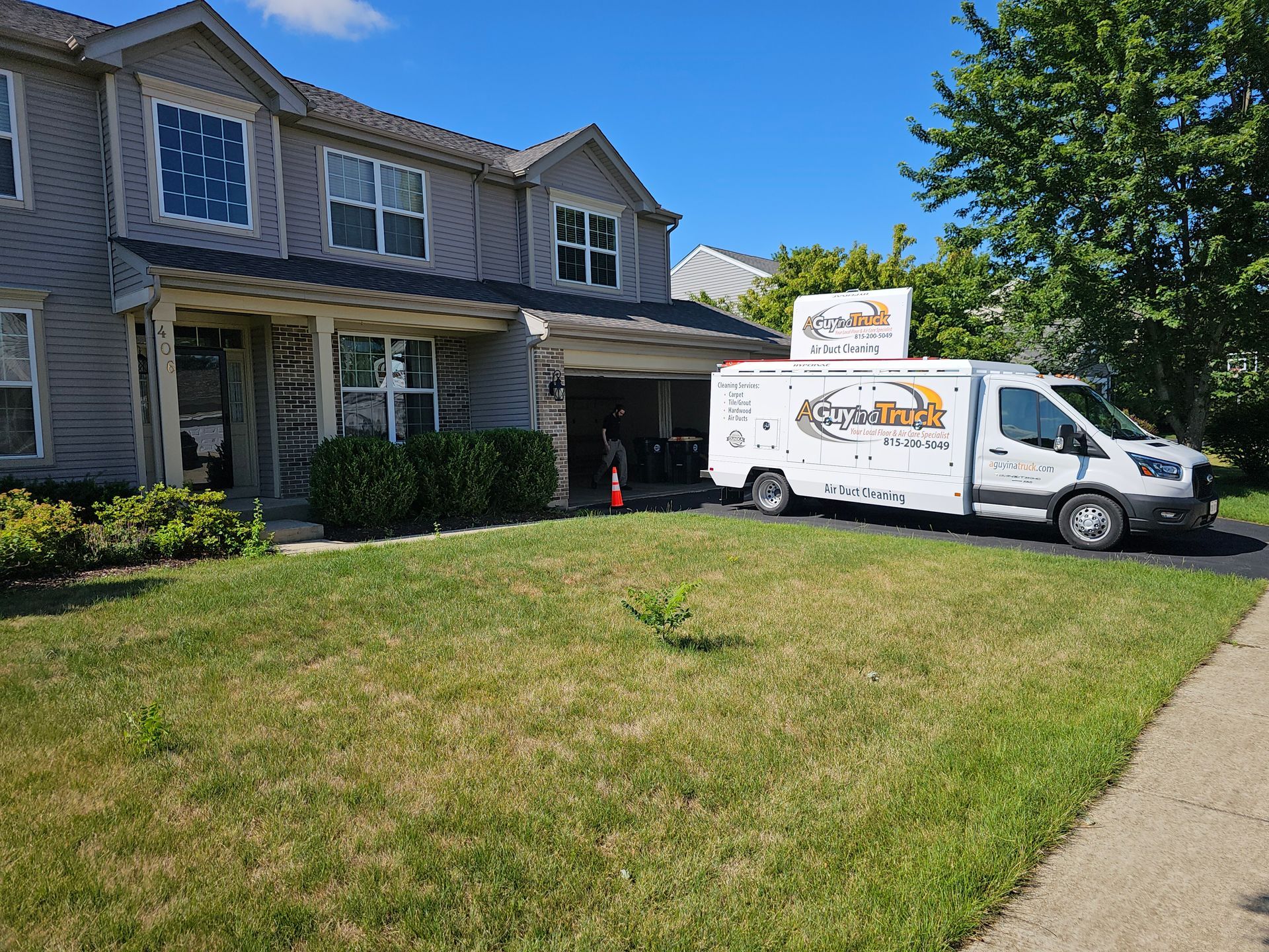 A Guy in a Truck air duct cleaning vehicle parked outside a suburban home in the Fox Valley area.