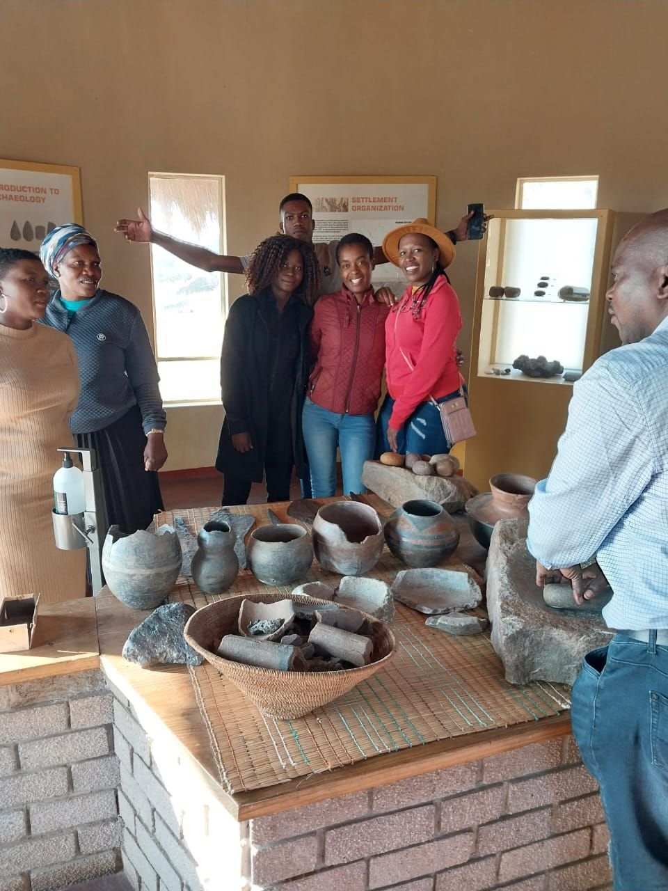 A group of people are posing for a picture in a museum