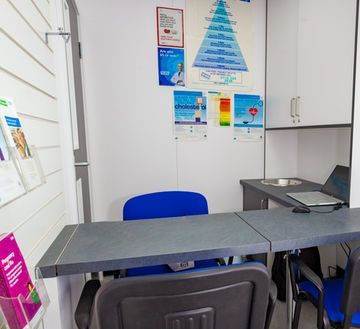 A room with a table and chairs and a laptop on it