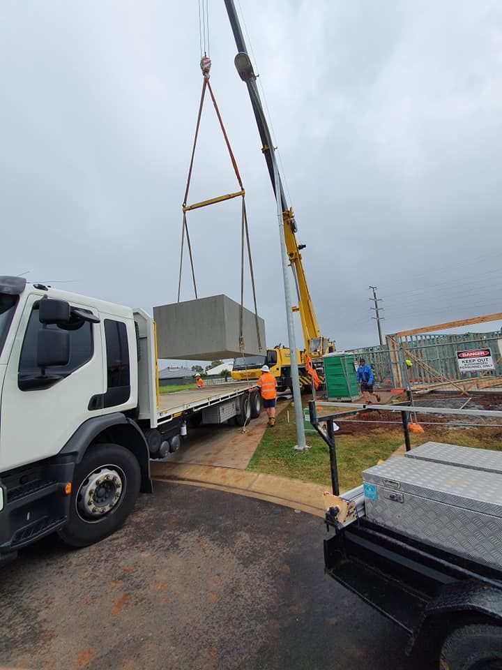 A Truck is Being Lifted by a Crane on a Construction Site — Jason Walsh Constructions in Alstonville, NSW
