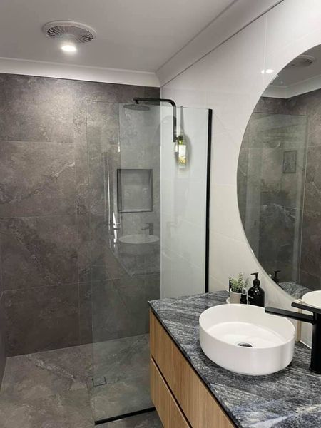 A Bathroom With a Sink, Mirror and Walk in Shower — Jason Walsh Constructions in Alstonville, NSW