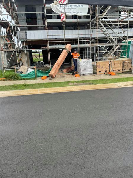 A Man is Standing in Front of a Building Under Construction — Jason Walsh Constructions in Alstonville, NSW