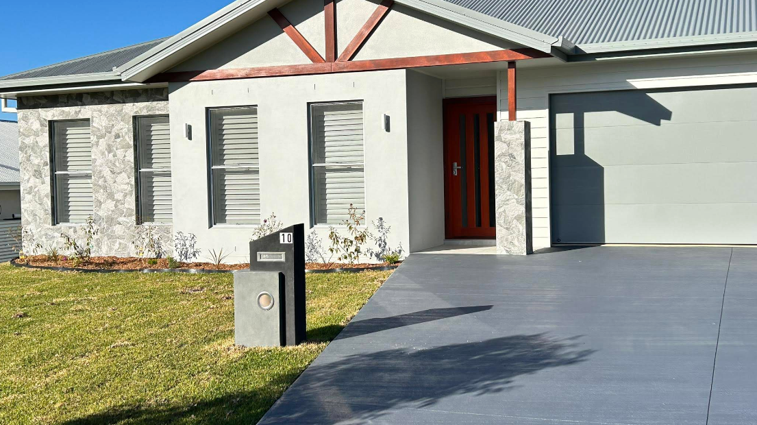A house with a driveway and a mailbox in front of it  — Jason Walsh Constructions in Alstonville, NSW