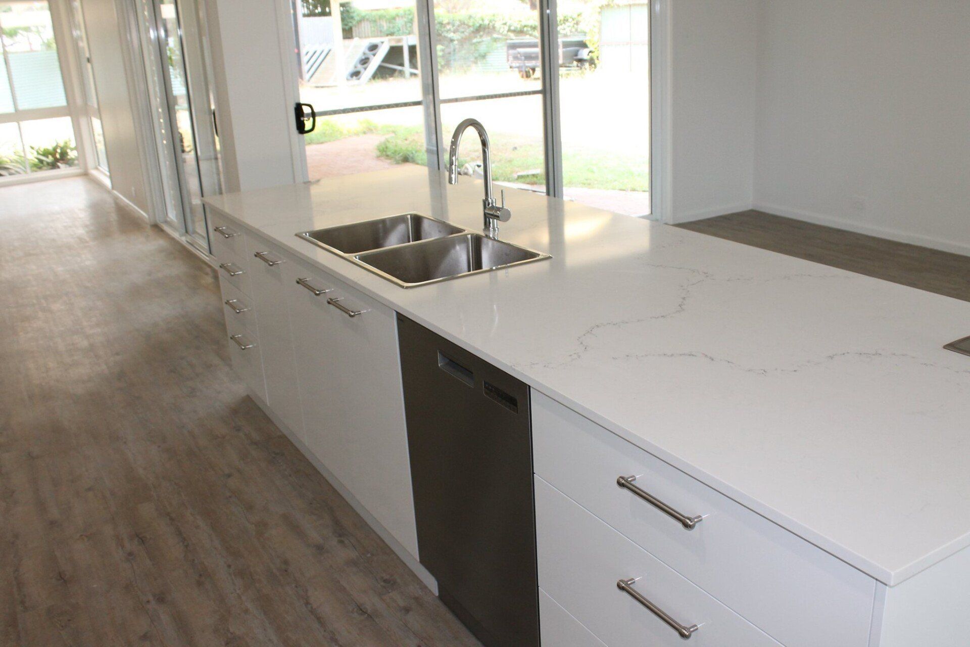 A kitchen with two sinks and a dishwasher — Jason Walsh Constructions in Mullumbimby, NSW