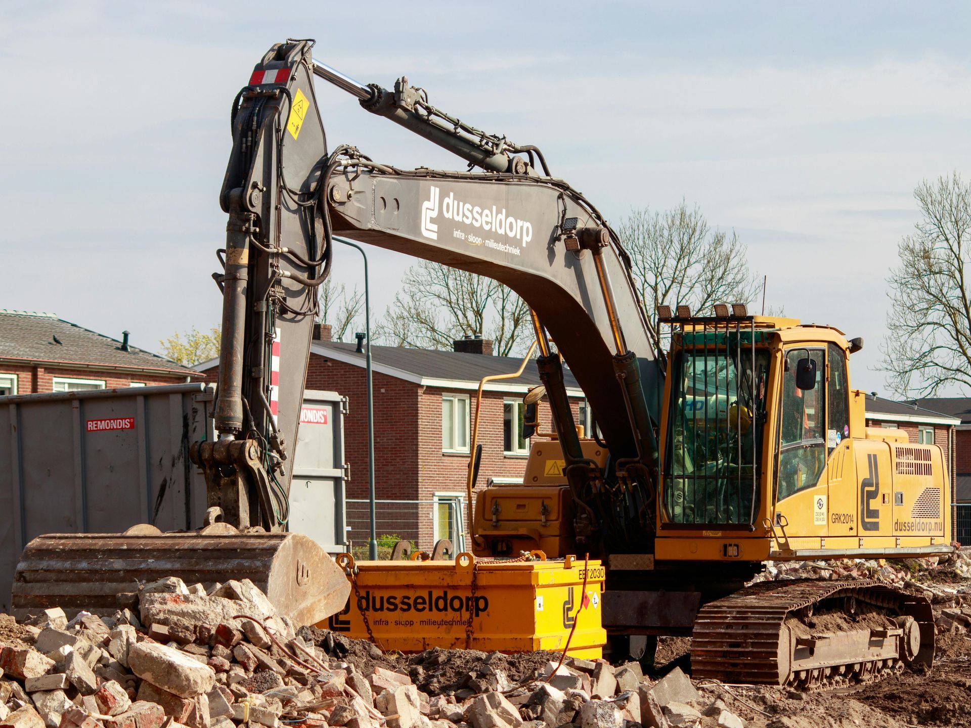 A yellow excavator with the word dusseldorp on it