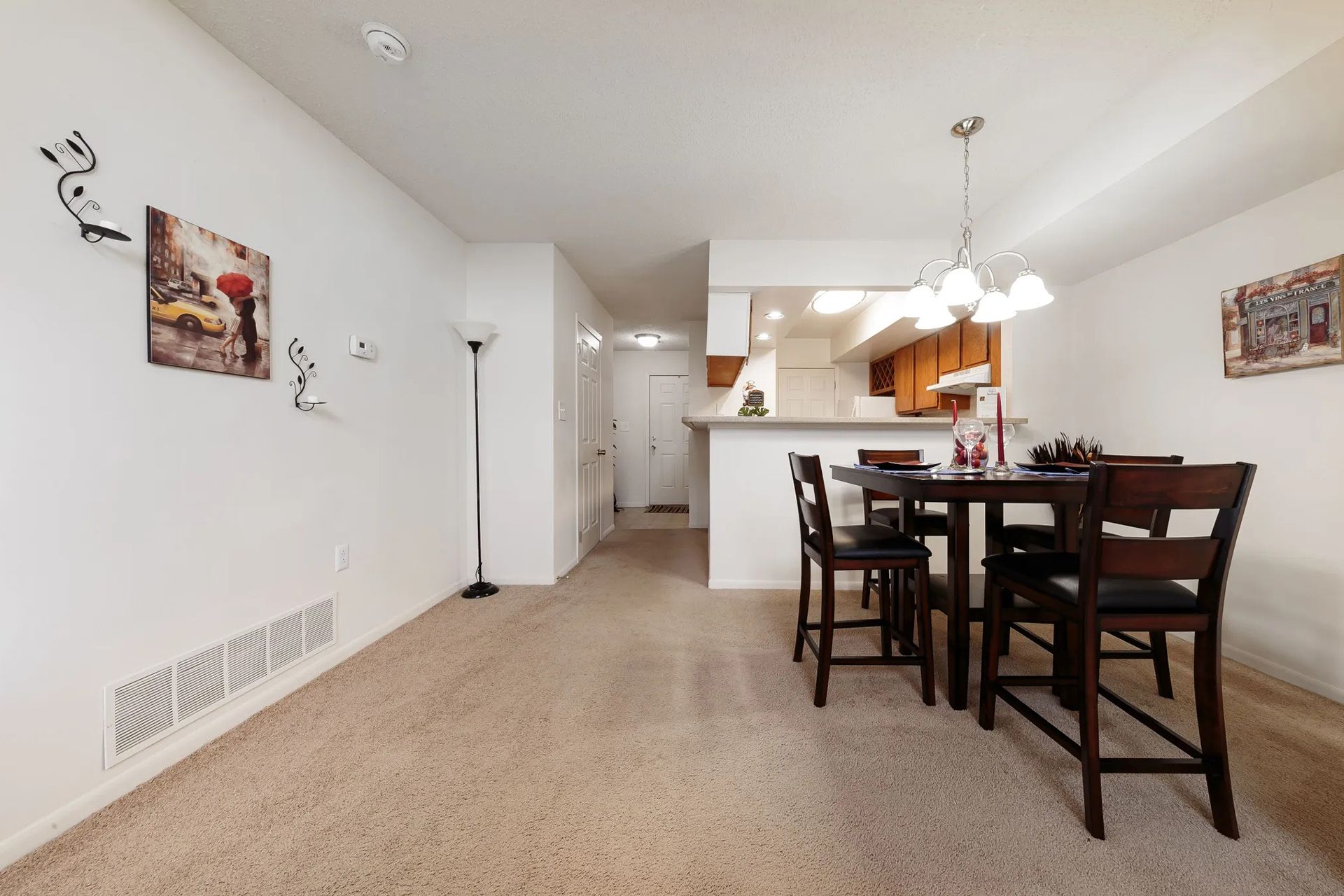 Small dining area with a table and chairs, open to the kitchen, and entryway.