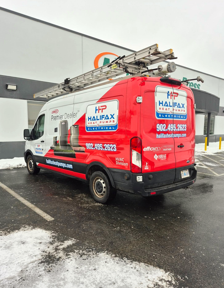 White and red HP Halifax van parked in front of a store with a ladder on top.
