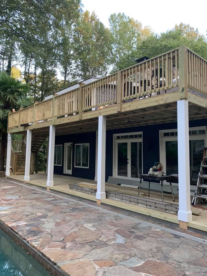 Aluminum under-decking that includes a hardscaping design, three ceiling fans, and outdoor lighting under construction.