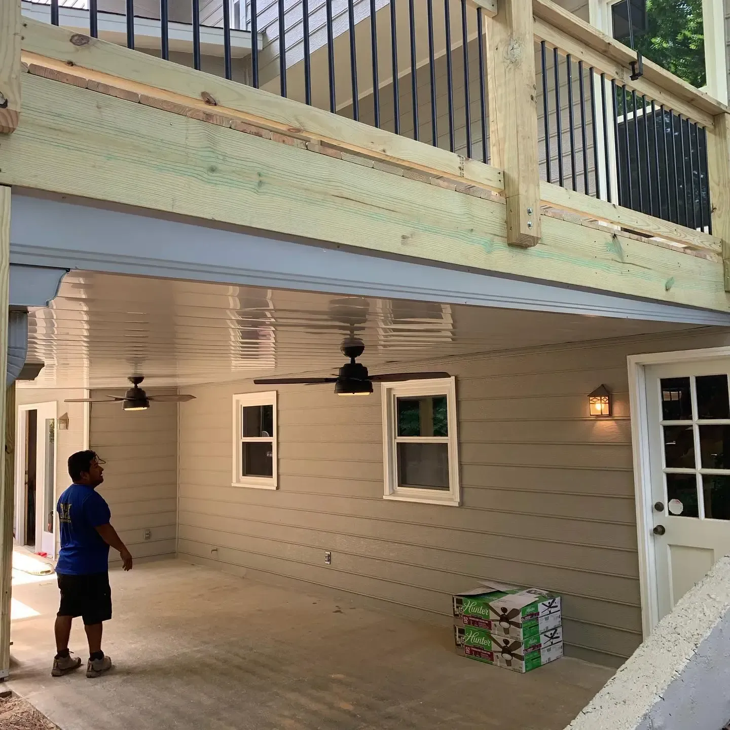 After installing white colored aluminum under-deck ceiling with LED lighting and ceiling fans.