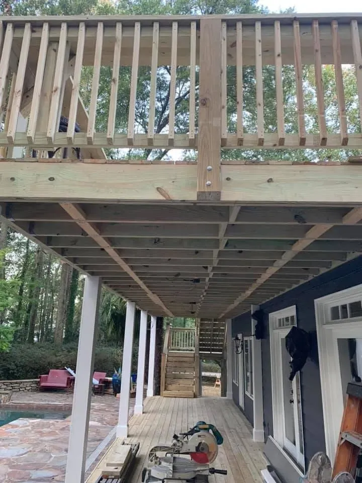 Before installing white aluminum under deck ceiling system with two ceiling fans and LED lighting features.