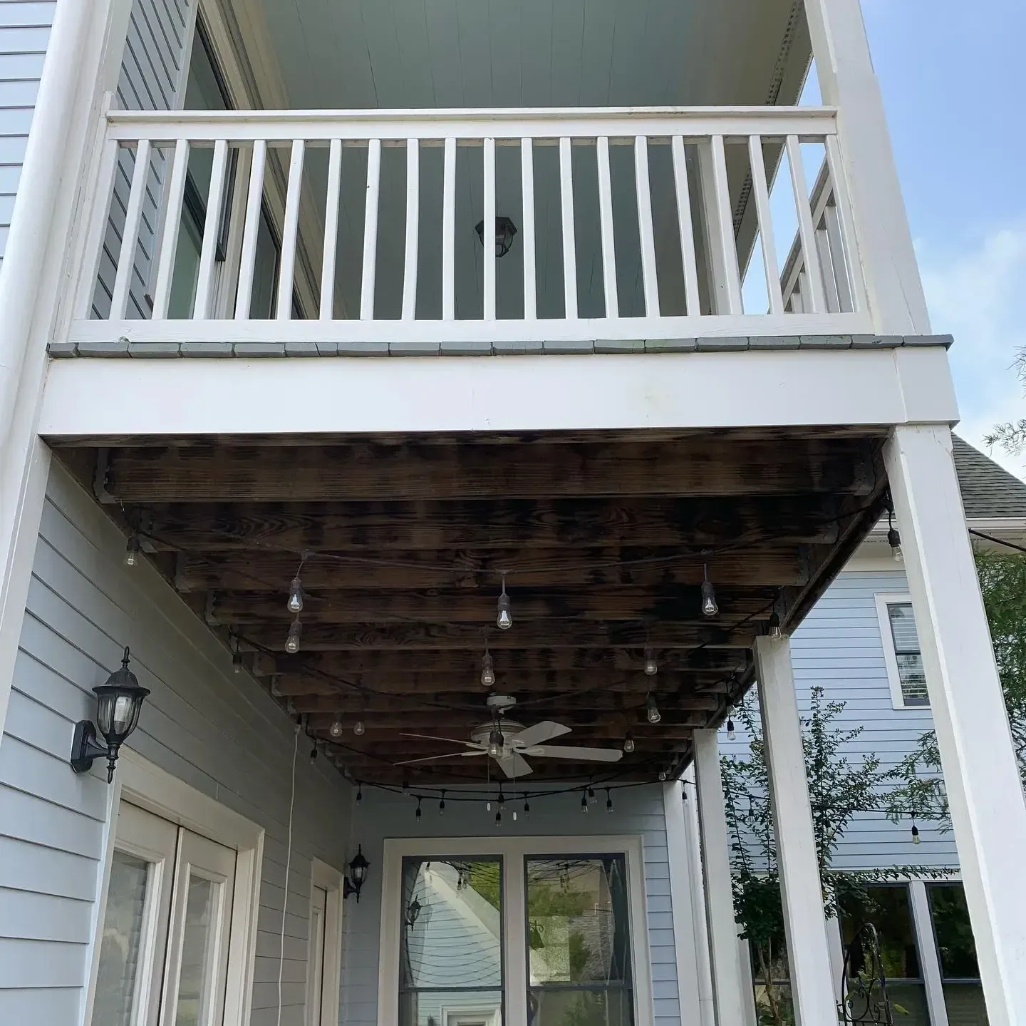 Before installing white colored aluminum under deck system with ceiling fan and outdoor lighting features.