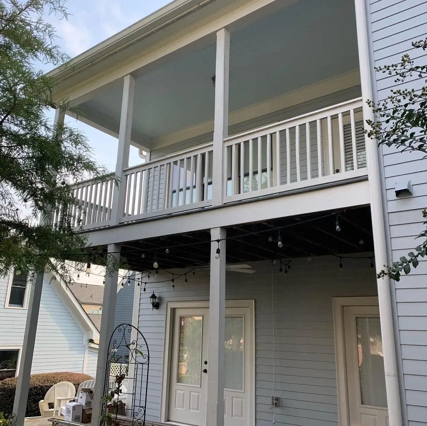 Before installing white panel under deck ceiling with ceiling fan and outdoor lighting features.