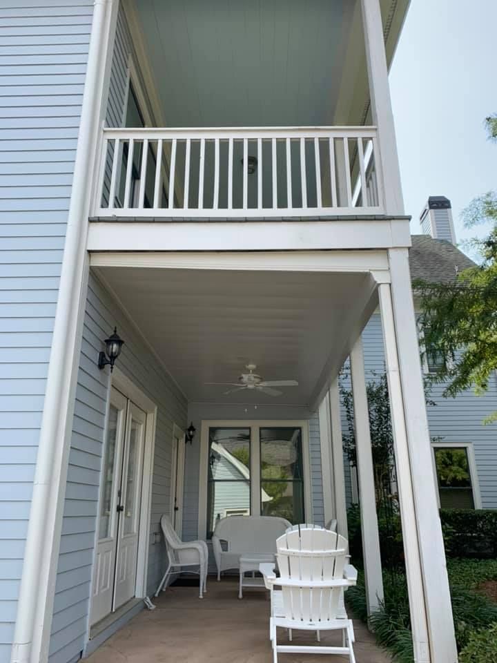 White aluminum under-deck ceiling that includes a hardscaping design, one ceiling fan, and outdoor lighting.