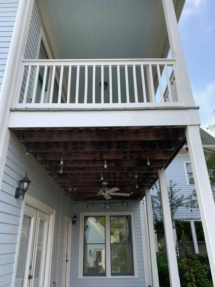 Aluminum under-deck ceiling that includes a hardscaping design, one ceiling fan, and outdoor lighting under construction.