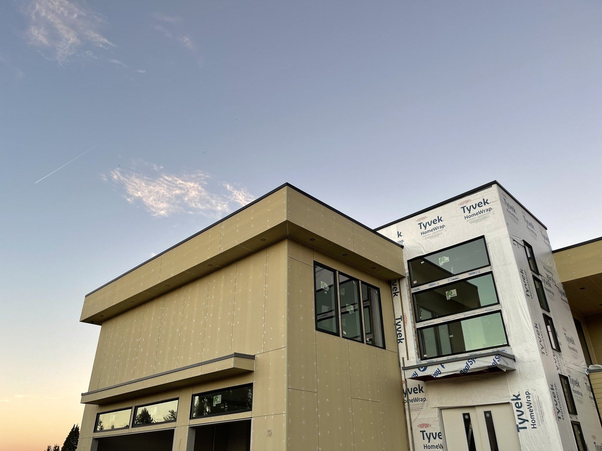 A large building with a lot of windows is under construction.
