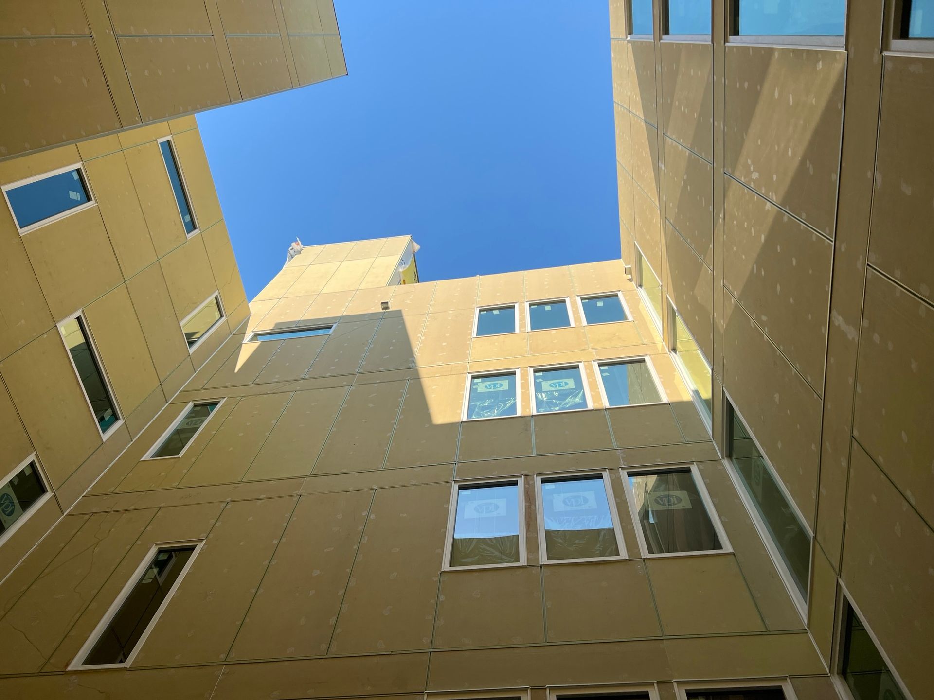 Looking up at a building with a blue sky in the background