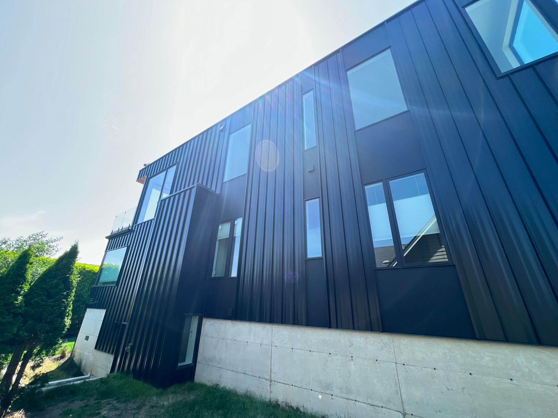 A large black building with a lot of windows on a sunny day.