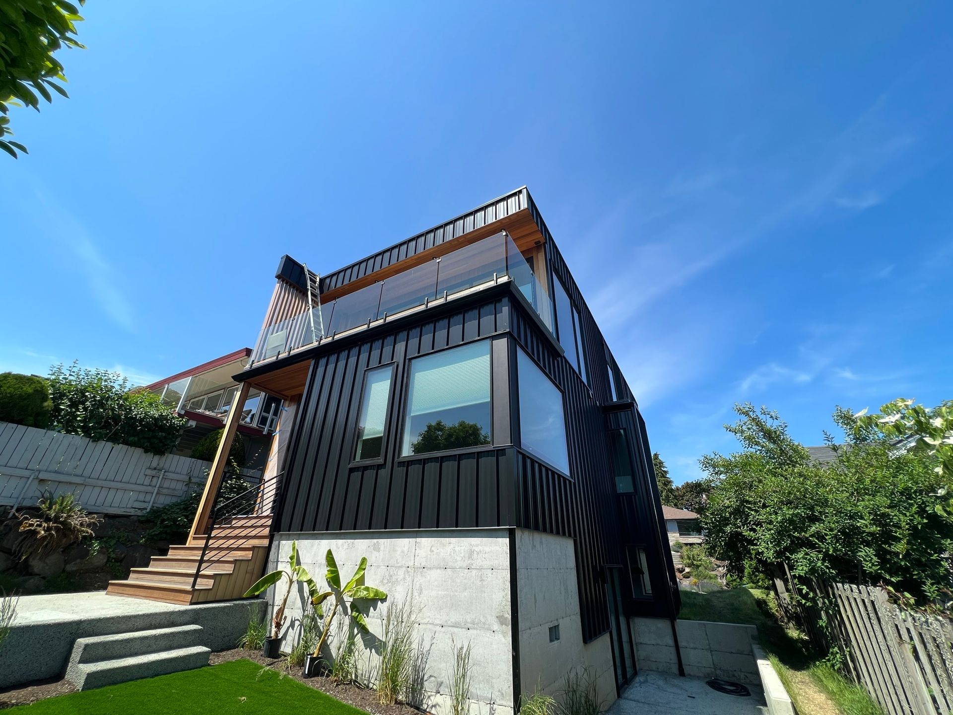 A large house with a lot of windows is sitting on top of a hill.