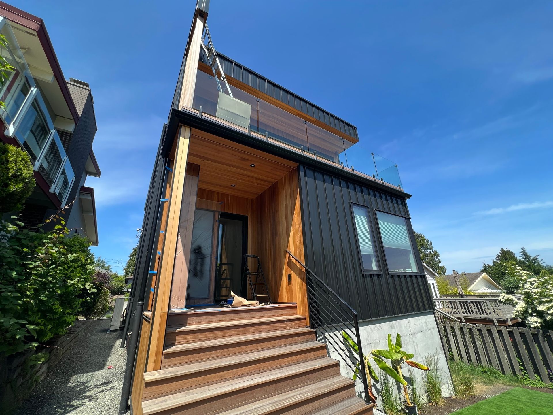 A small house with stairs leading up to it and a blue sky in the background.